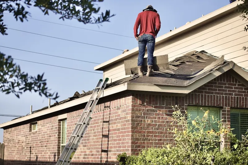 Professional roofer working on a residential roof in Navesink